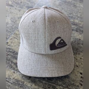 Men's Quicksilver tan colored flexfit fitted hat.